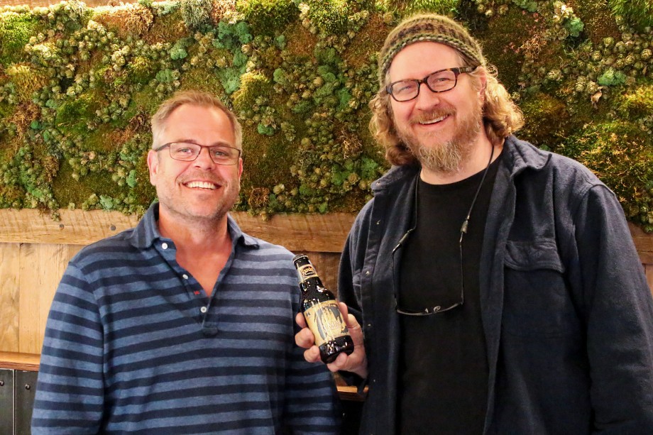 Mike and Dave holding a bottle of Palm Reader