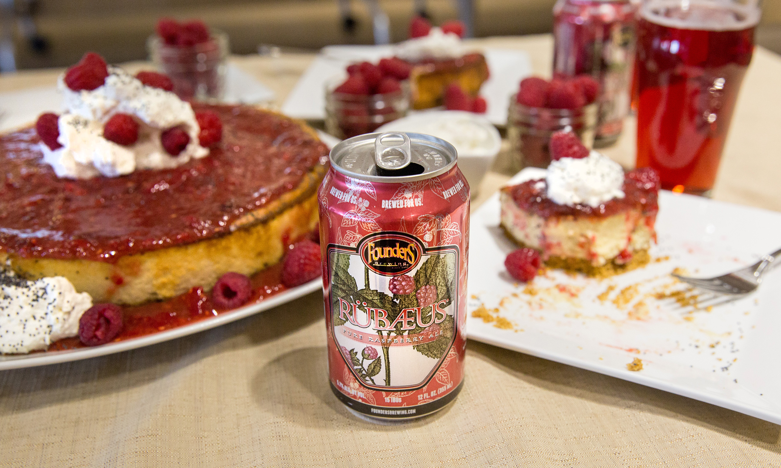 Can of Founders Rübaeus surrounded bu raspberry desserts