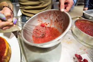 Mixing raspberries in a bowl