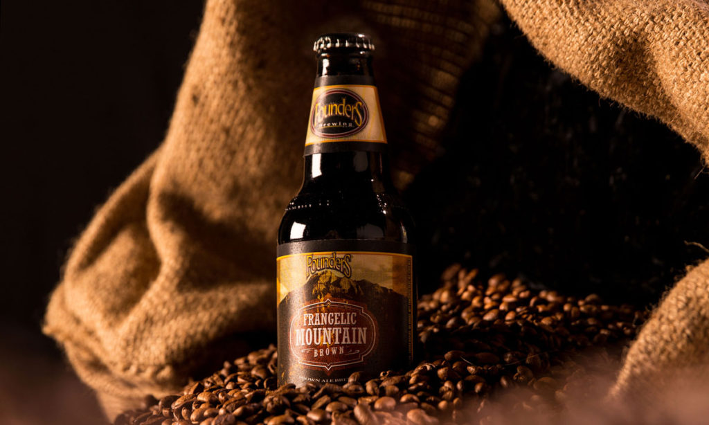 Bottle of Founders Frangelic Mountain Brown sitting in espresso beans