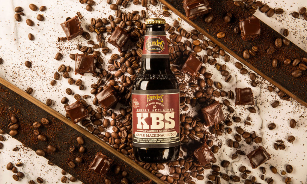 bottle of KBS Maple Mackinac Fudge surrounded by coffee beans and chunks of fudge