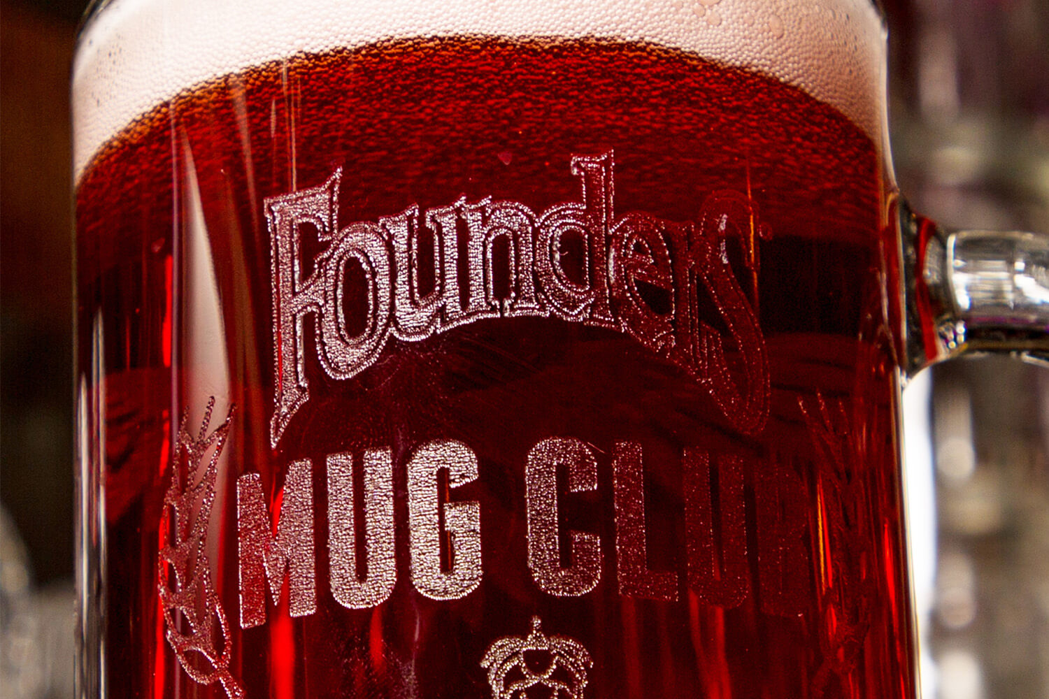 Beer mug full of beer with Founders Mug Club etched on the side
