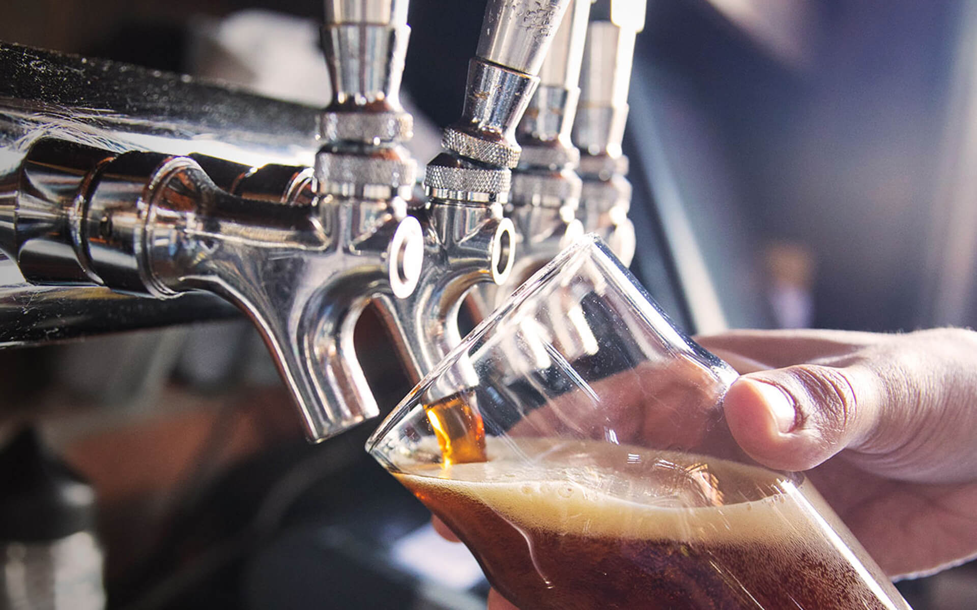 Tap pouring beer into a pint glass