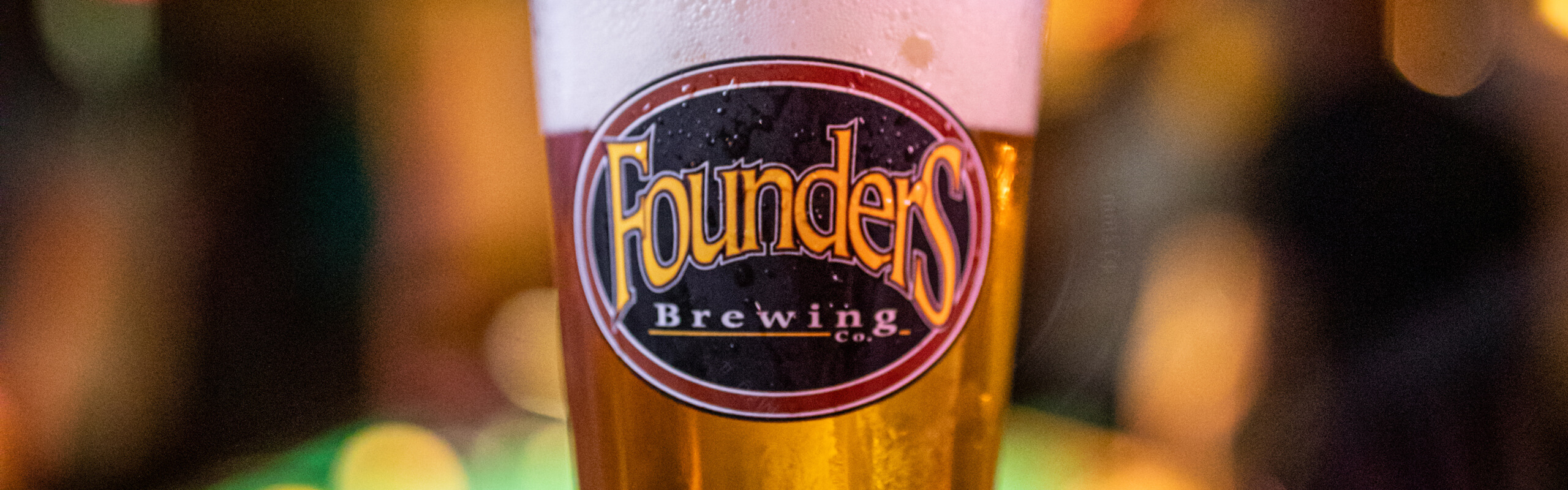 Close up of beer in a pint glass with Founders logo
