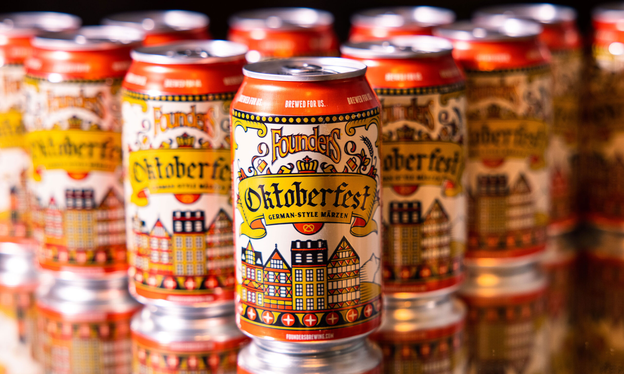 oktoberfest cans arranged in a series on top of a mirror