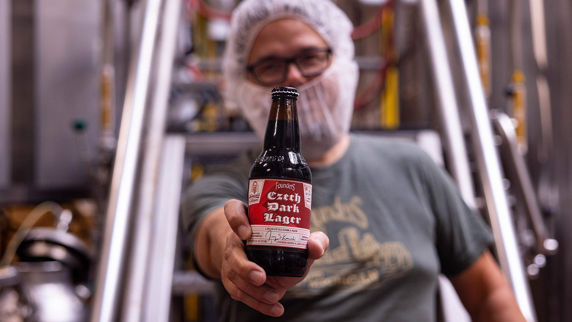 Jeremy Kosmicki holding Czech Dark lager